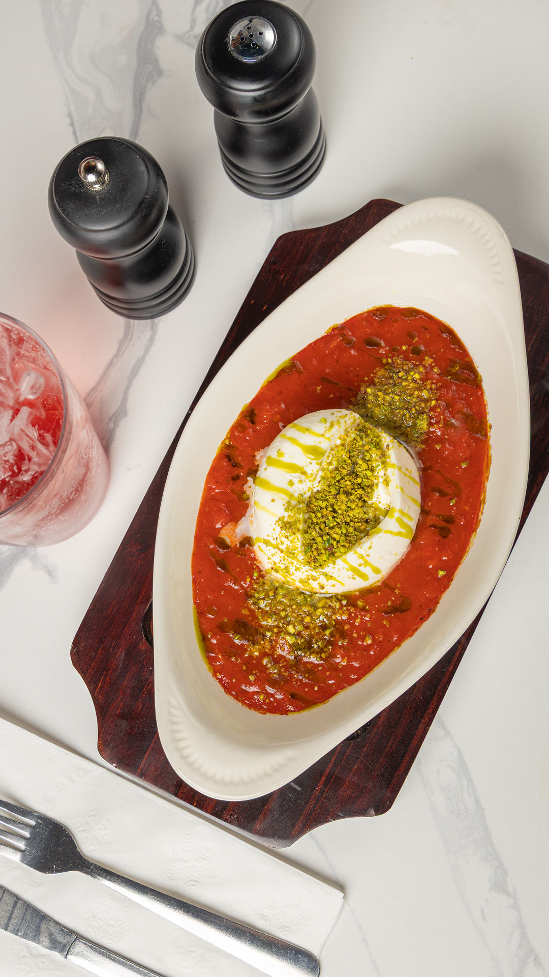 Burrata melted in sizzling marinara with toasted bread